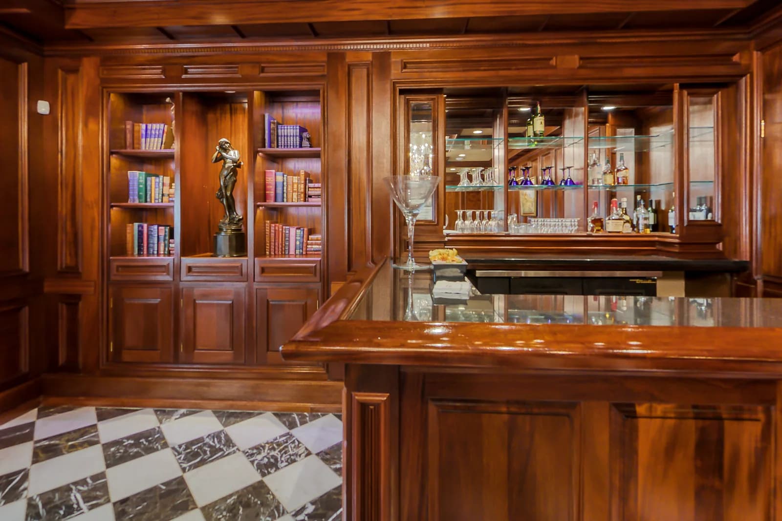 The Library at The Park Savoy Estate in Florham Park, NJ, with wood paneling, a curved bar and a checkered marble floor
