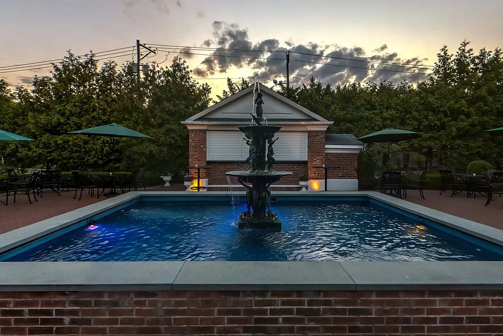 The fountain patio with umbrella tables at The Rockleigh