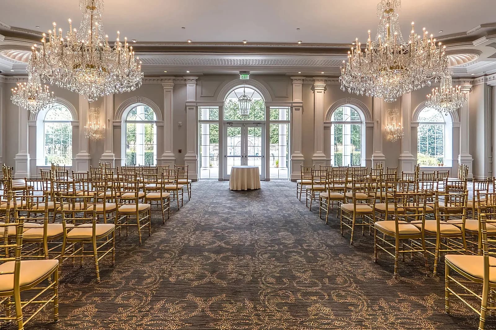 Chairs set for a ceremony in the Georgian Chapel at The Rockleigh, beneath crystal chandeliers