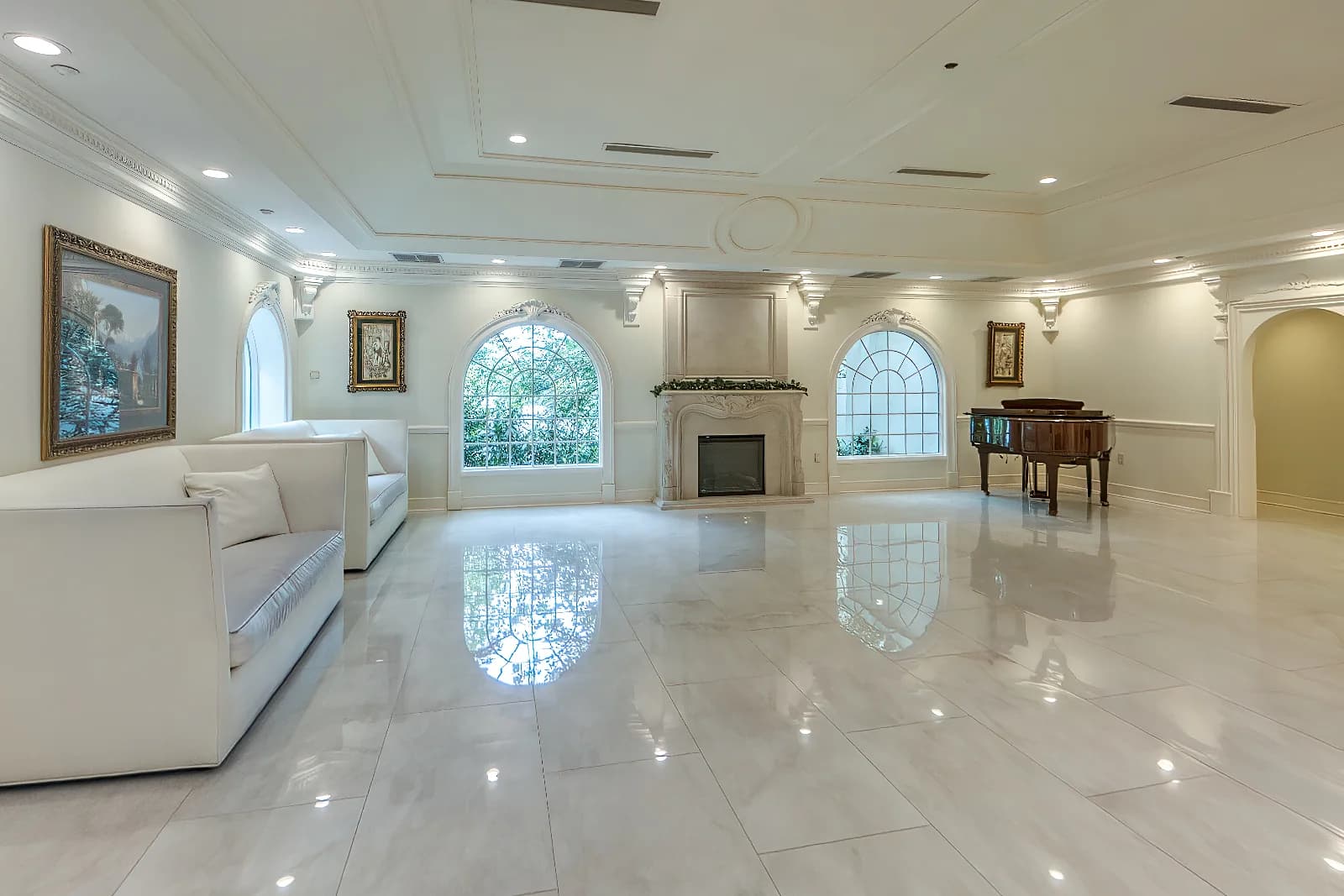 Lobby at Valley Regency in Clifton, NJ, with polished marble floors, a fireplace and white seating