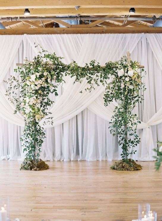 Green arch and drape wedding backdrop