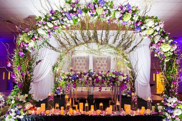 sweetheart table with flowers, greenery and, candles