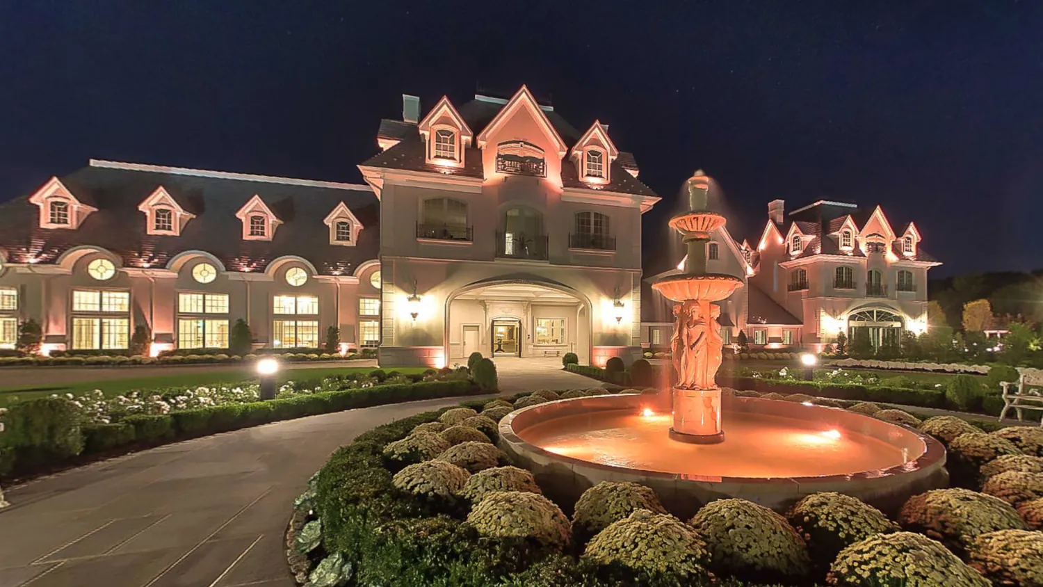 Park Chateau Estate exterior at night — French château façade with illuminated grounds, New Jersey wedding venue